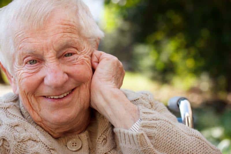 Carer assisting senior with home care package hours